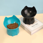 Blue and black raised tilted cat bowls, one filled with cat food | Pawnests