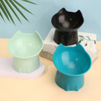 Green, black and blue raised tilted cat bowls on a pastel table | Pawnests